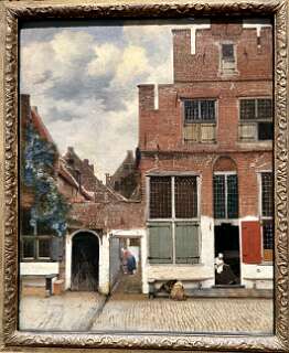 Dit is Het Straatje (ca. 1658) van de Nederlandse meester Johannes Vermeer. Het schilderij toont een pittoresk steegje met rode bakstenen huizen in Delft. Het hangt in het Rijksmuseum in Amsterdam.